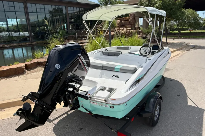 Slide: The Image of 2026 Tahoe T16 boat with Mercury engine, parked near a scenic pond. - 7