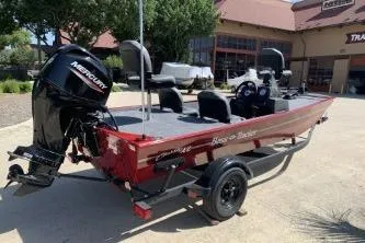 Slide: The Image of 2026 Tracker Bass Tracker Classic XL boat with Mercury engine, parked outdoors. - 4
