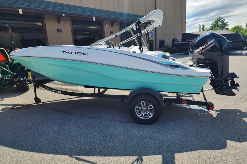 The Image of 2026 Tahoe T16 boat with Mercury engine on trailer, parked outdoors. - 0