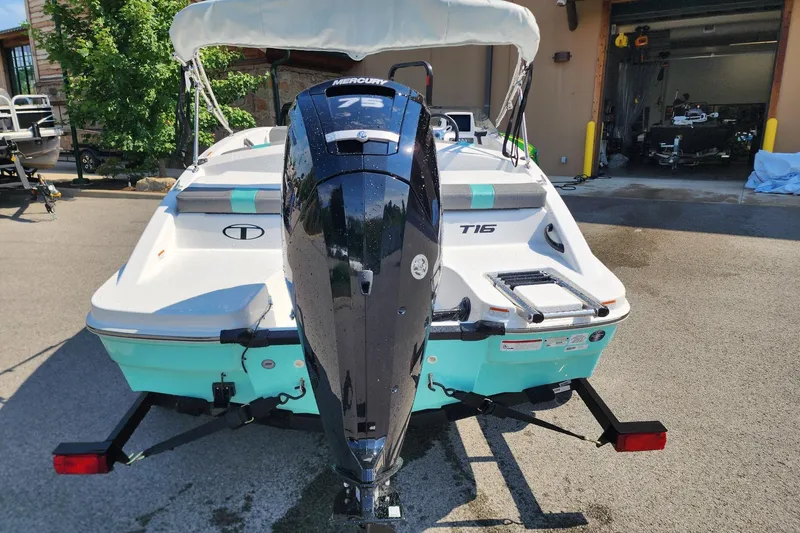 Slide: The Image of 2026 Tahoe T16 boat with Mercury 75 engine, parked outdoors. - 2