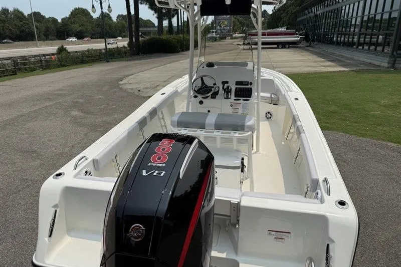 Slide: The Image of 2026 Mako 214 Center Console boat with powerful V8 engine, parked outdoors. - 7