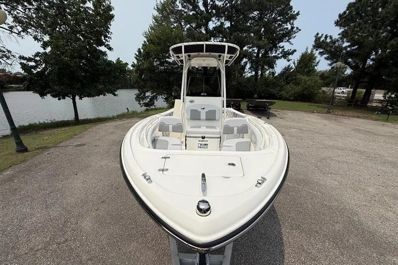 Slide: The Image of 2026 Mako 214 Center Console boat parked near a scenic lake. - 8