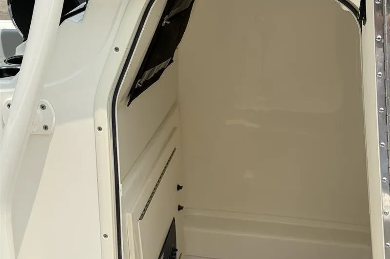Slide: The Image of 2026 Mako 214 Center Console interior cabin, showcasing spacious and clean design. - 19