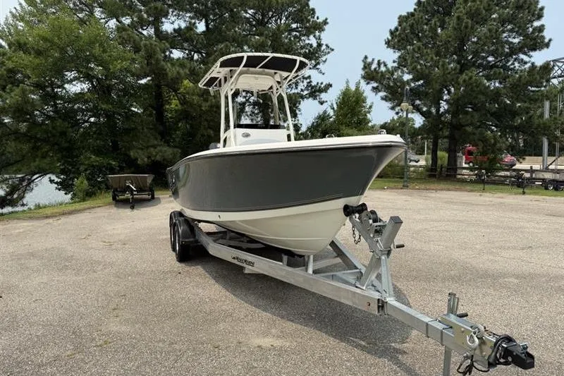 Slide: The Image of 2026 Mako 214 Center Console boat on trailer in a wooded area. - 5