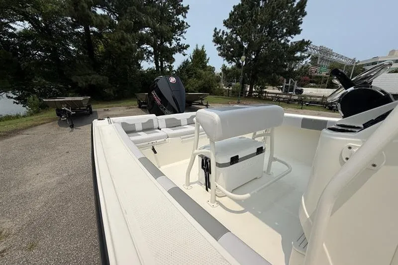Slide: The Image of 2026 Mako 214 Center Console boat with seating and console, parked outdoors. - 18