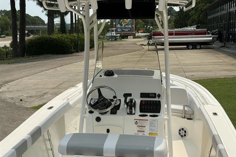 Slide: The Image of 2026 Mako 214 Center Console boat interior with steering wheel and control panel. - 11
