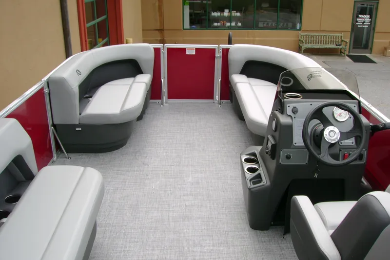 Slide: The Image of 2026 Sun Tracker Party Barge 16 DLX interior with seating and steering console. - 6