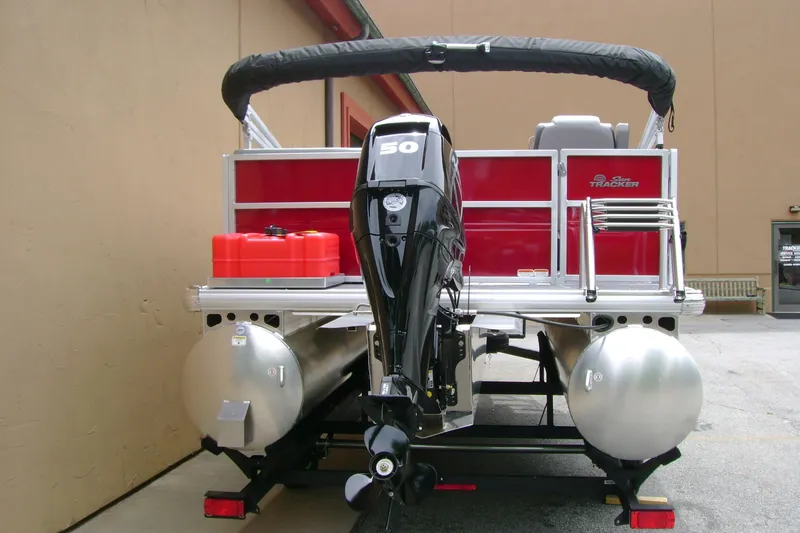 Slide: The Image of 2026 Sun Tracker Party Barge 16 DLX pontoon boat with outboard motor, rear view. - 4