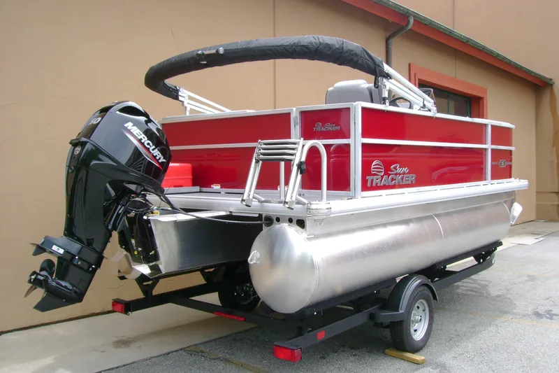 Slide: The Image of 2026 Sun Tracker Party Barge 16 DLX pontoon boat with Mercury outboard motor on trailer. - 2