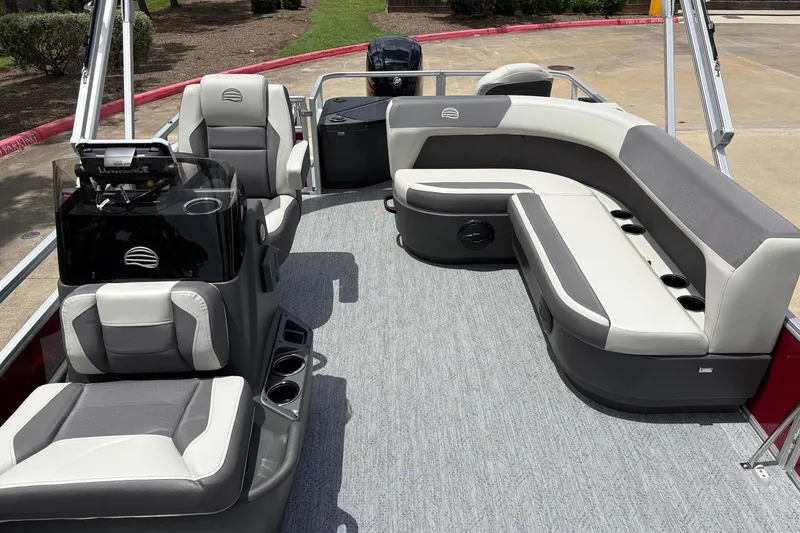 Slide: The Image of 2026 Sun Tracker Bass Buggy 18 DLX pontoon boat interior with gray seating and helm. - 5