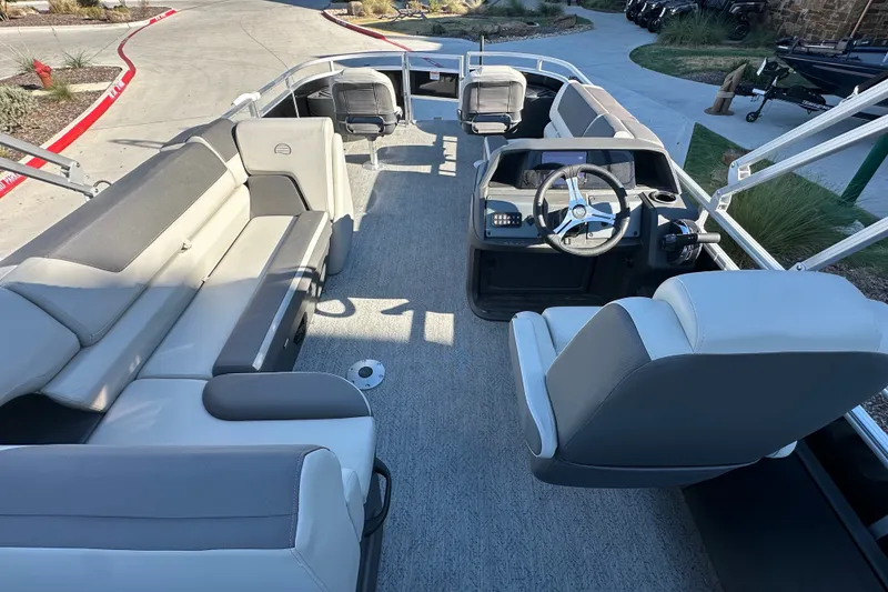 Slide: The Image of 2026 Sun Tracker Fishin' Barge 22 DLX interior with spacious seating and modern helm. - 19