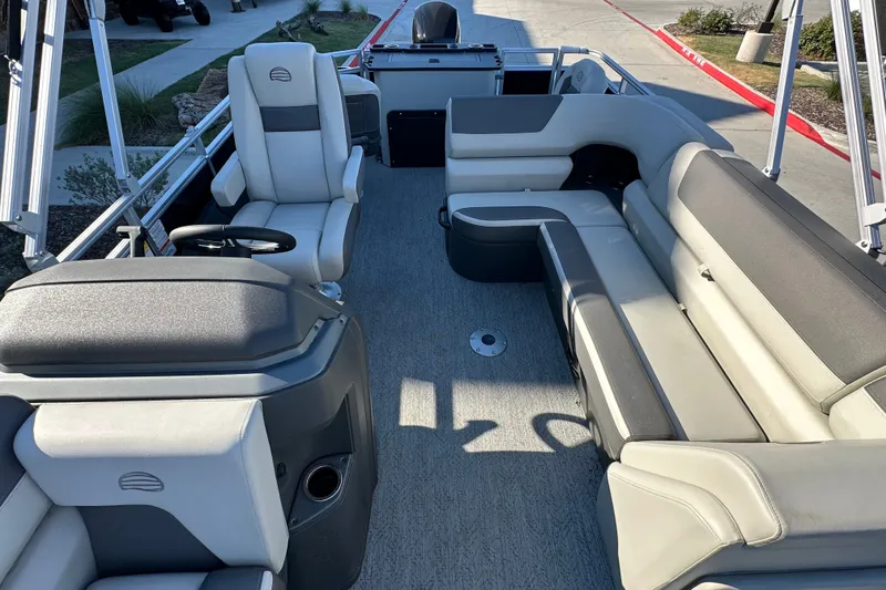 Slide: The Image of 2026 Sun Tracker Fishin' Barge 22 DLX interior with spacious seating and modern design. - 20