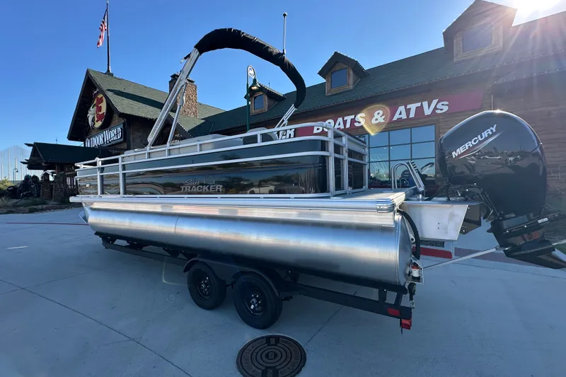 The Image of 2026 Sun Tracker Fishin' Barge 22 DLX pontoon boat with Mercury engine at dealership. - 1