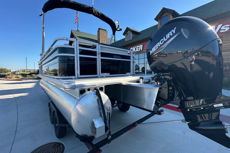 Slide: The Image of 2026 Sun Tracker Fishin' Barge 22 DLX with Mercury outboard motor, parked outside dealership. - 14