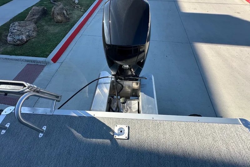 Slide: The Image of 2026 Sun Tracker Fishin' Barge 22 DLX boat engine and deck view. - 23