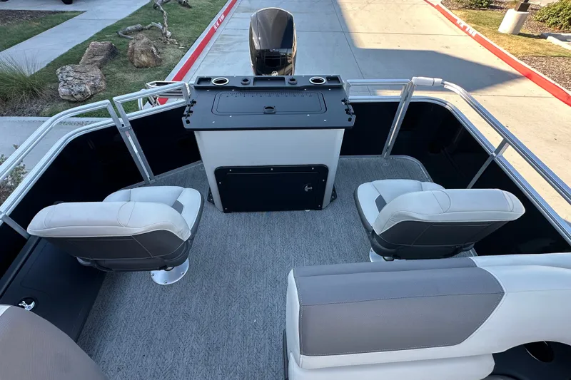 Slide: The Image of 2026 Sun Tracker Fishin' Barge 22 DLX interior with seating and control console. - 21