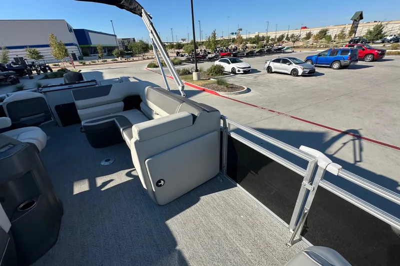 Slide: The Image of 2026 Sun Tracker Fishin' Barge 22 DLX pontoon boat interior in a parking lot. - 18