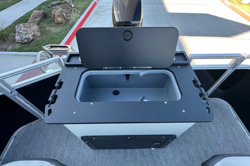 Slide: The Image of Livewell on 2026 Sun Tracker Fishin' Barge 22 DLX pontoon boat, open lid view. - 22
