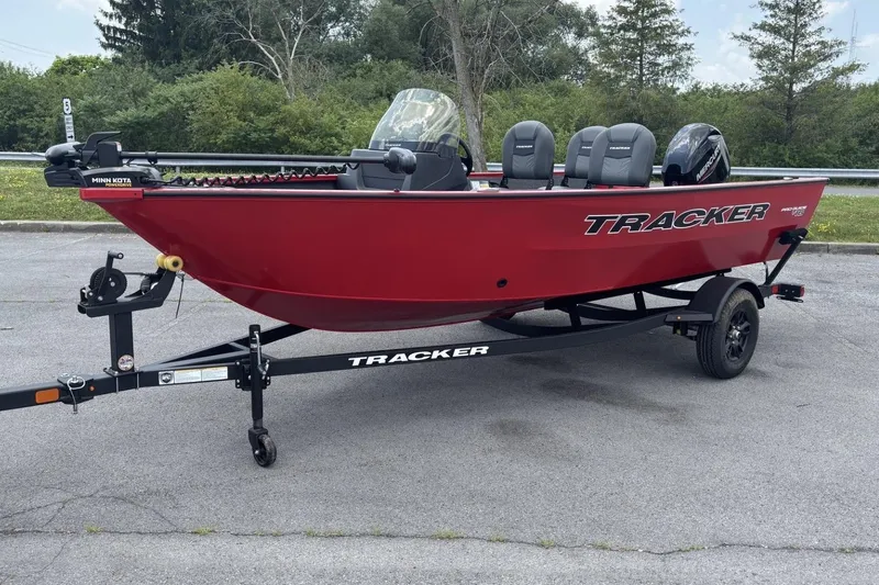 Slide: The Image of Red 2026 Tracker Pro Guide V-16 SC boat on trailer, parked outdoors. - 4