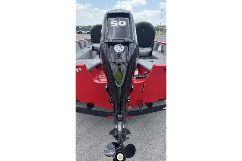 Slide: The Image of 2026 Tracker Pro Guide V-16 SC boat with a 50 HP outboard motor, red exterior. - 2