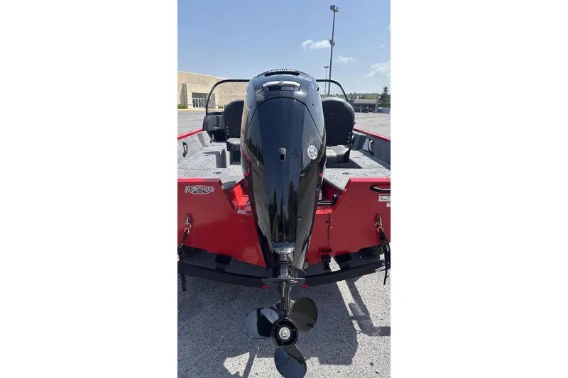 Slide: The Image of 2026 Tracker Pro Guide V-16 WT boat with powerful outboard motor, parked outdoors. - 5