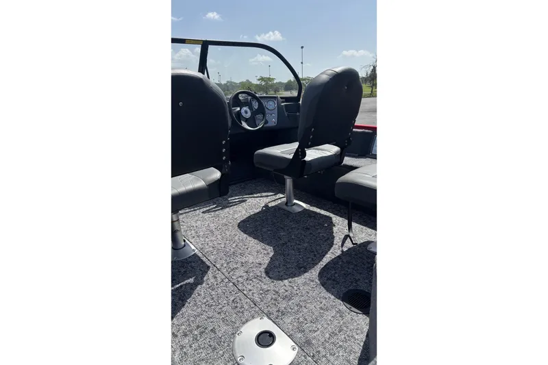Slide: The Image of Interior view of 2026 Tracker Pro Guide V-16 WT boat with seating and steering console. - 3