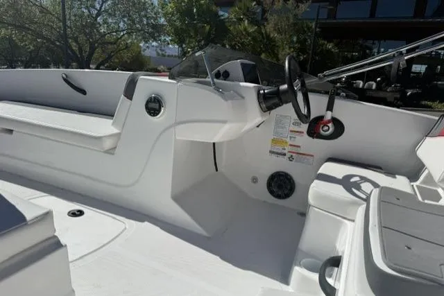 Slide: The Image of 2026 Tahoe T18 boat interior with steering wheel and seating, showcasing modern design. - 6