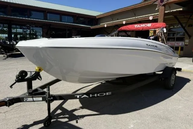 Slide: The Image of 2026 Tahoe T18 boat on trailer, displayed outdoors at a dealership. - 3