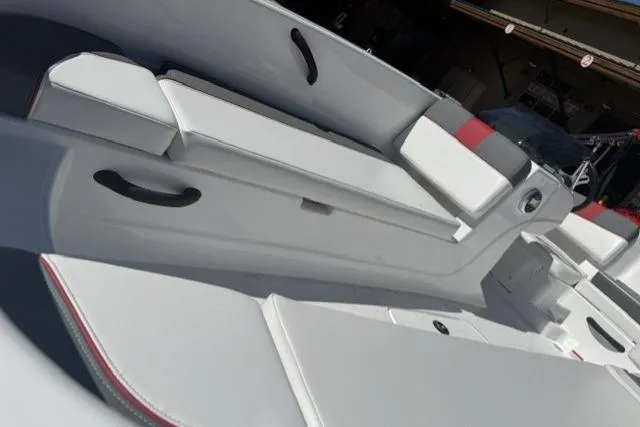 Slide: The Image of 2026 Tahoe T18 boat interior with white seating and black handles. - 8