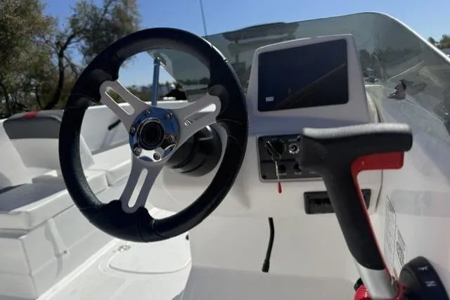 Slide: The Image of Steering wheel and dashboard of 2026 Tahoe T18 boat, featuring modern controls and sleek design. - 5