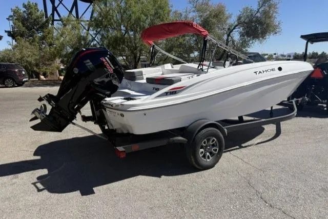 Slide: The Image of 2026 Tahoe T18 boat on trailer with red canopy in sunny outdoor setting. - 1
