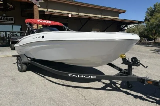 The Image of 2026 Tahoe T18 boat with red canopy on trailer, parked outdoors. - 0