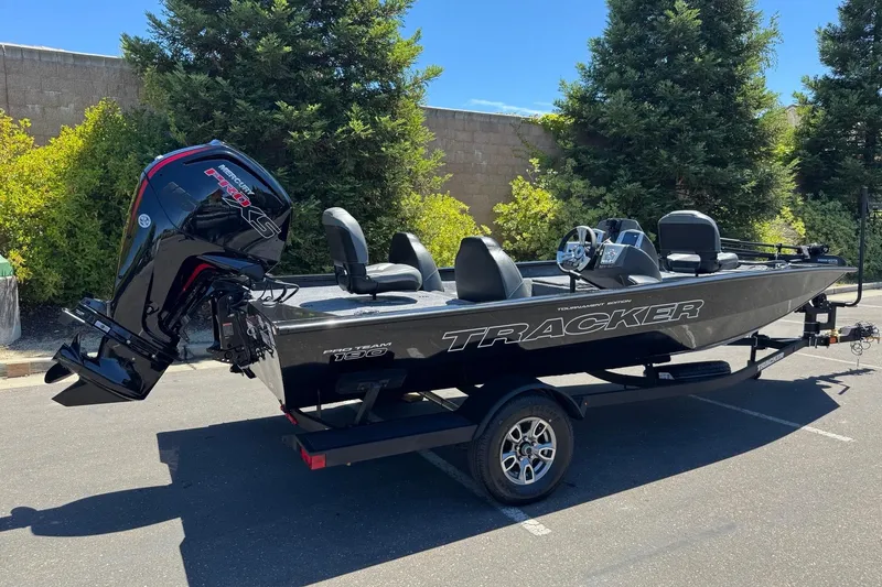 Slide: The Image of 2026 Tracker Pro Team 190 boat with Mercury engine, parked outdoors. - 2