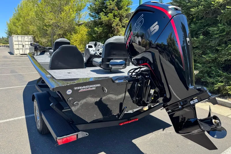 Slide: The Image of 2026 Tracker Pro Team 190 boat with powerful outboard motor in a sunny parking lot. - 5