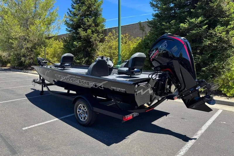 Slide: The Image of 2026 Tracker Pro Team 190 boat in a parking lot, featuring sleek design and powerful engine. - 3