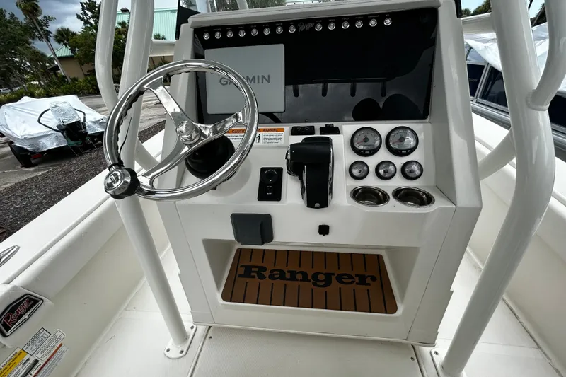 Slide: The Image of 2025 Ranger 2600 Bay boat console with steering wheel, gauges, and Garmin display. - 13