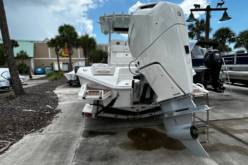 Slide: The Image of 2025 Ranger 2600 Bay boat with powerful outboard motor, parked outdoors. - 1