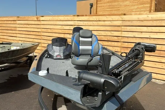 Slide: The Image of 2026 Ranger RT178 fishing boat with trolling motor and seating, parked outdoors. - 1