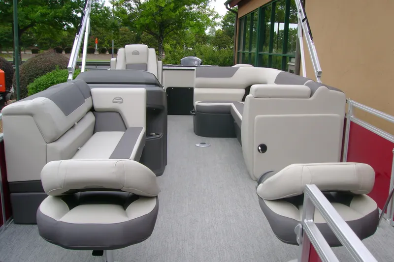 Slide: The Image of 2026 Sun Tracker Fishin' Barge 22 DLX interior with plush seating and modern design. - 5
