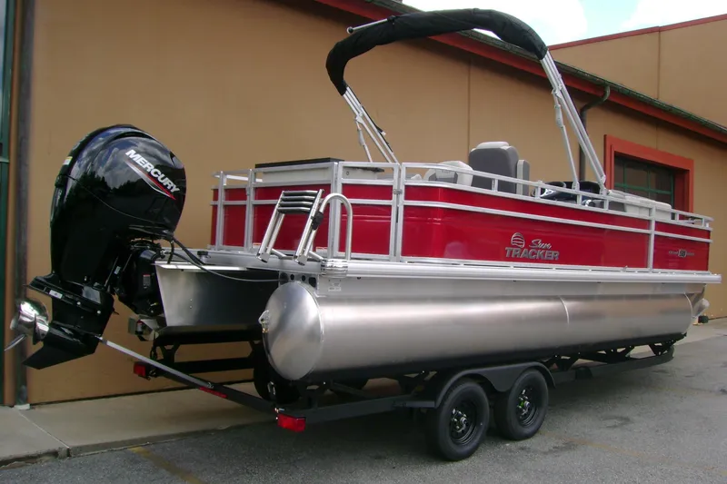 Slide: The Image of 2026 Sun Tracker Fishin' Barge 22 DLX pontoon boat with Mercury outboard motor. - 2
