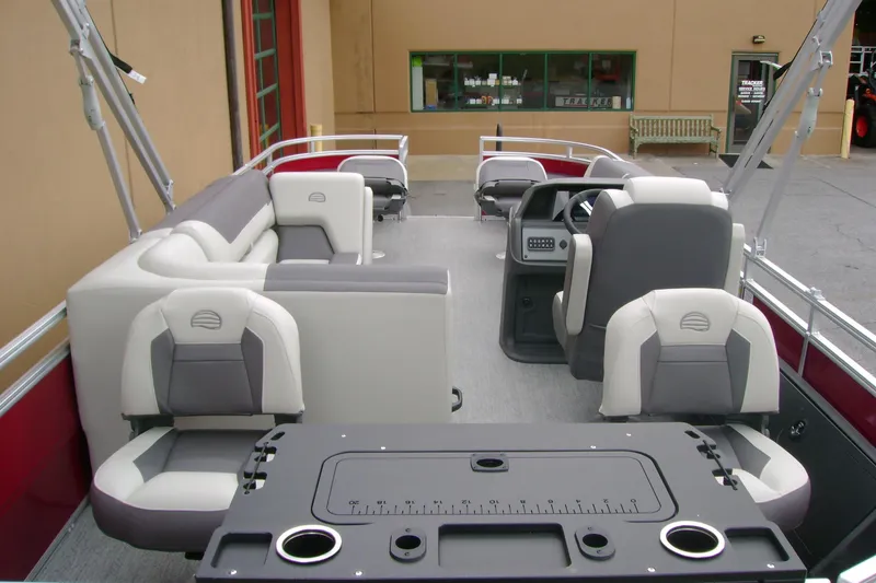 Slide: The Image of 2026 Sun Tracker Fishin' Barge 22 DLX interior with seating and fishing station. - 6