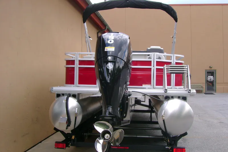 Slide: The Image of 2026 Sun Tracker Fishin' Barge 22 DLX pontoon boat with powerful outboard motor. - 4