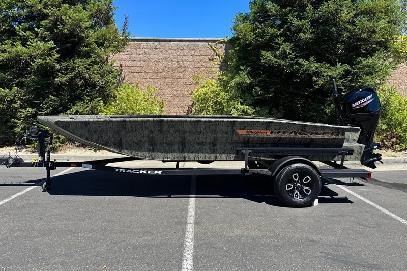 Slide: The Image of 2026 Tracker Grizzly 1756 T Marsh boat on trailer, parked outdoors. - 3