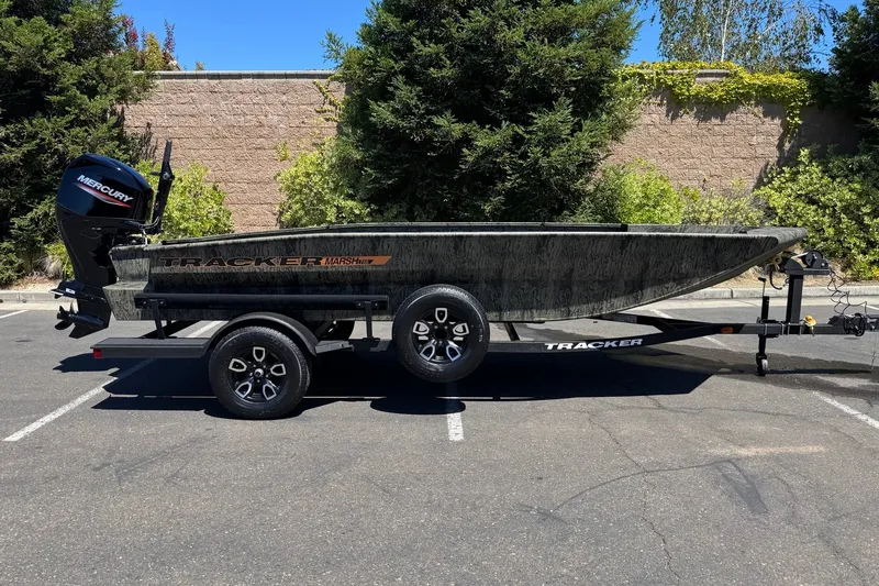 The Image of 2026 Tracker Grizzly 1756 T Marsh boat on trailer, parked outdoors. - 0