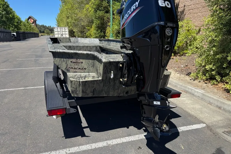 Slide: The Image of 2026 Tracker Grizzly 1756 T Marsh boat with Mercury 60 engine in parking lot. - 6
