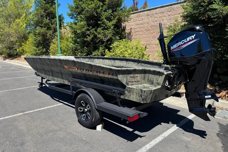 Slide: The Image of 2026 Tracker Grizzly 1756 T Marsh boat with Mercury engine in parking lot. - 4