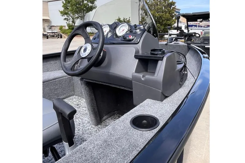 Slide: The Image of 2026 Tracker Super Guide V-16 SC boat interior with steering wheel and dashboard controls. - 2