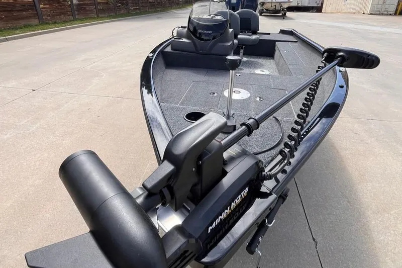 Slide: The Image of 2026 Tracker Super Guide V-16 SC boat with Minn Kota trolling motor on concrete surface. - 3