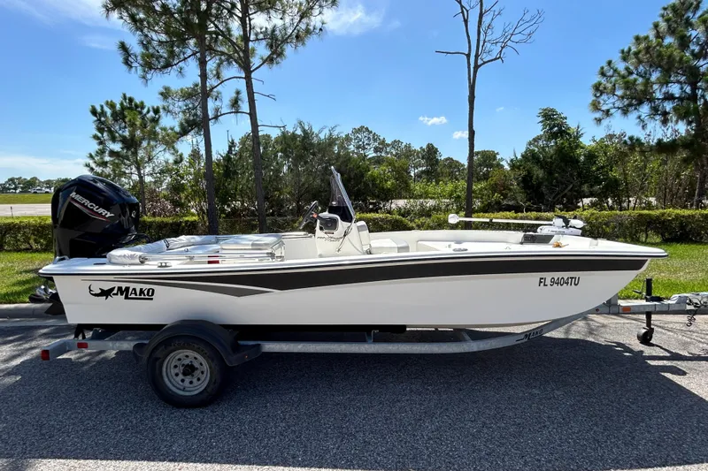 The Image of 2024 Mako Pro Skiff 17 CC boat on trailer, parked outdoors. - 0