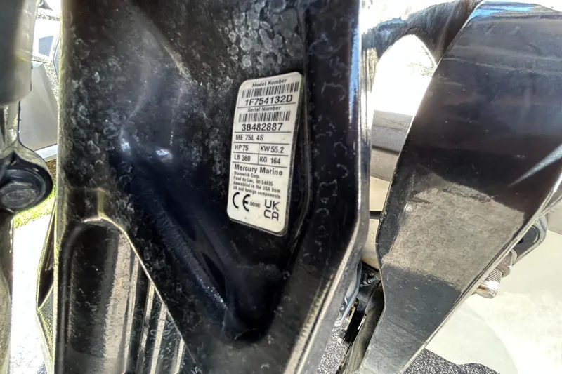 Slide: The Image of Close-up of Mercury Marine engine label on 2024 Mako Pro Skiff 17 CC boat. - 13